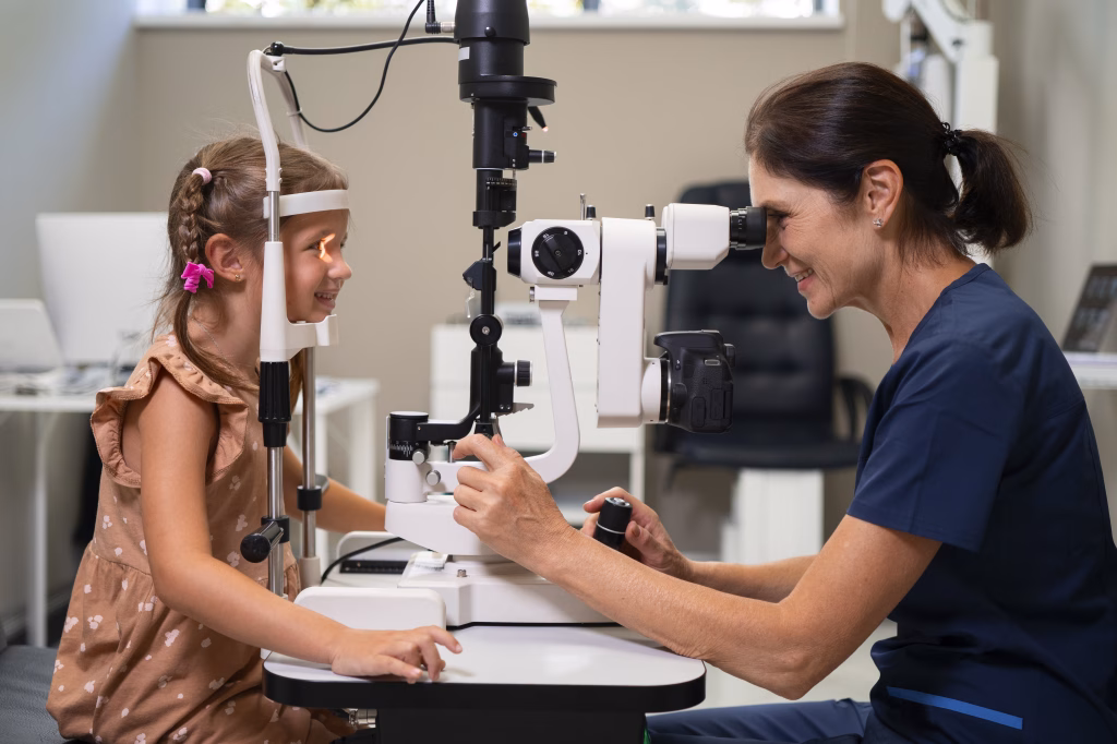 female ophthalmology giving young girl eye exam office