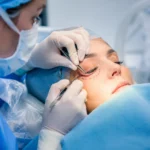 lower blepharoplasty eyelid surgery procedure showing surgeon performing precise under-eye correction in a sterile clinical setting