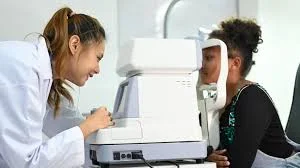 images Autorefractor eye testing machine measuring refractive error before a comprehensive eye examination.